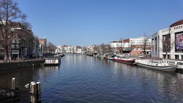 A view down the Amstel canal in the city of Amsterdam on a beautiful day in spring.