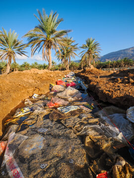 Plastic waste pollution in irrigation canal Socotra copy space