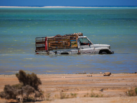 Off-road pickup truck stuck in high tide water copy space
