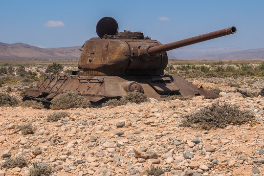 Rusty T-34 tank wreck abandoned in desert landscape, Socotra