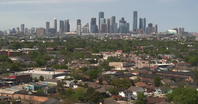 Drone Flight Over Residential Homes and Commercial Strip, Downtown Houston Distant
