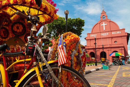 Colonial Red and Floral Colors: An Artistic Perspective of a Trishaw at Christ Church Melaka, Malaysia
