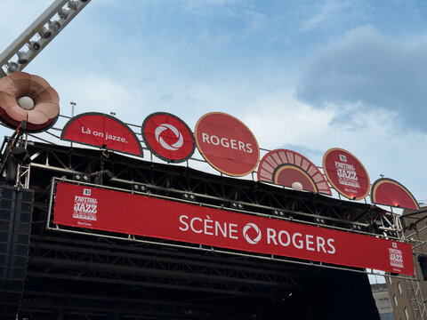 Rogers sponsored main stage structure displays circular sponsor signs during Montreal International Jazz Festival - Montreal, Canada - July 1, 2025