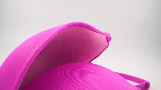 Close up of pink bra cup with smooth fabric texture.