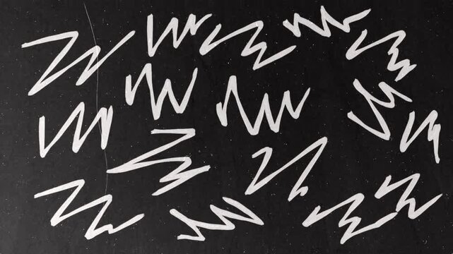 White marker scribbles appearing on black background