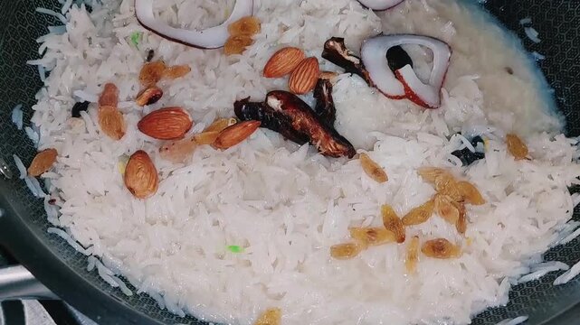 Garnishing Mutanjan Zarda With Premium Dry Fruits Nuts