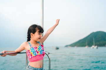 Girl child happy summer vacation sea boat sailboat outdoor travel lineated barbet bird feed nest...
