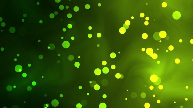A mesmerizing video background of green and yellow bokeh lights shining brightly in a dark room for a creative visual effect