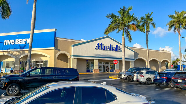 Marshalls retail store exterior with palm trees and parked cars in a shopping plaza, featuring clear signage and bright blue sky