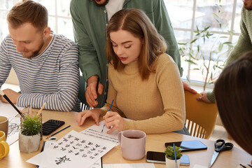 Group of young people during courses of calligraphy
