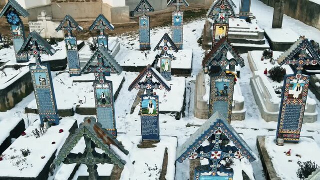 Merry cemetery crosses in Sapanta village Romania during winter season with snow covered monuments.