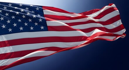Fototapeta premium American flag waving in the wind with a clear blue sky