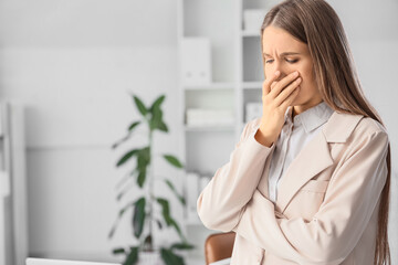 Fototapeta premium Portrait of worried young woman in office