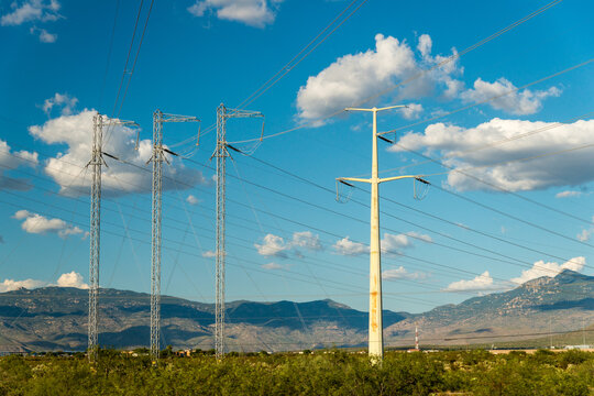USA, Arizona, Tucson.  High voltage transmission lines tower over the landscape south of the city.