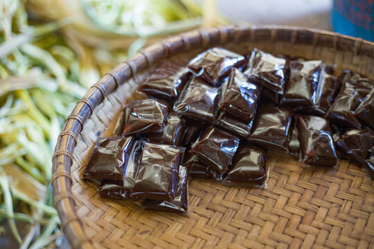 Dodol, or jenang, is a snack made from glutinous rice flour, coconut milk, and brown sugar, sometimes mixed with fruits such as durian and soursop, and wrapped in woka (Livistona rotundifolia) leaves.