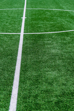 Soccer field with green grass and white line, sport background.