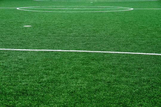 Soccer field with green grass and white line, sport background.