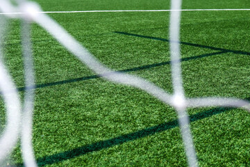 Soccer field green grass and net background. Football or soccer field © ponsulak