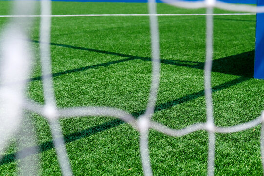 Soccer field green grass and net background. Football or soccer field