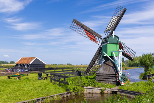 Traditional windmill standing in Zaanse Schans Netherlands rural landscape