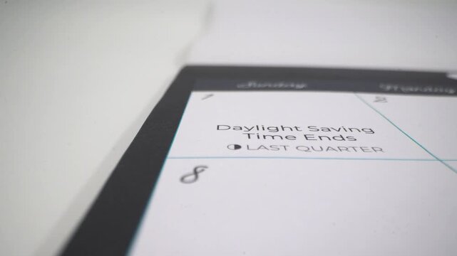 Close up of calendar showing daylight saving time ends reminder.