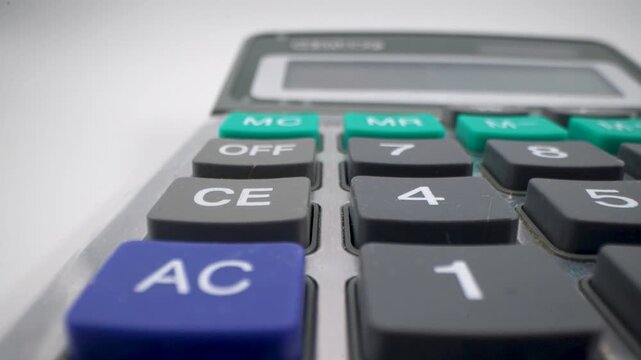Close up of calculator keypad with numbers and function buttons.