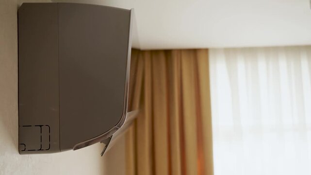 Side View of Modern Wall-Mounted Air Conditioner in Home Interior. Open split system air conditioning unit. Concept of climate control, home comfort, and modern appliance design
