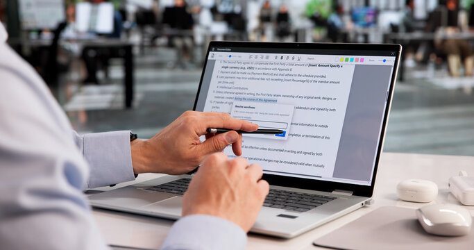 Meticulous Proofreader Examines Laptop Document, Fixing Spelling Mistakes