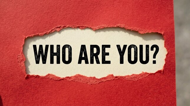 Red paper torn open at center revealing bold black text &ldquo;WHO ARE YOU&rdquo; on white background, dramatic contrast creating sense of curiosity, introspection, and striking visual emphasis on hidden message.