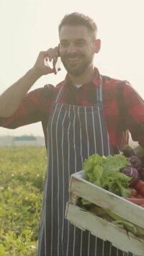 Farmer discusses produce, Bright morning scene features farmer coordinating large vegetable order with client