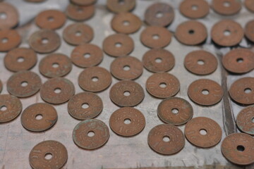 Scattered Pile of Antique Copper Coins with Center Holes © Mas