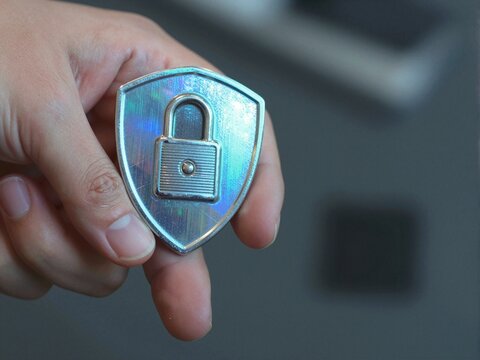 Hand Holding Security Token with Holographic Shield
