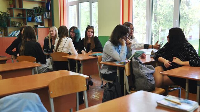 Teenagers engaging in group work and discussions, fostering teamwork and communication skills within an educational setting