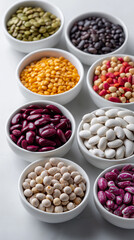 Fototapeta premium Assortment of colorful beans in white bowls arranged neatly on table