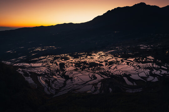 Sunrise glows over the thousand-year-old rice terraces, a living legacy shaped by generations of the Hani people.