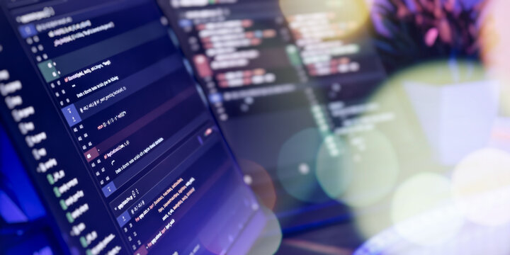 Close-up of coding screens in modern workspace