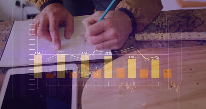 Pencil poised, designer pointing notebook and sketching on wooden table, charts updating for design