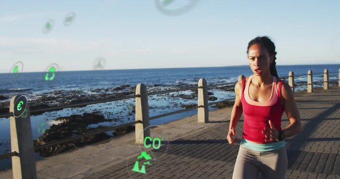 Runner entering right, running toward camera along coast while green icons floating, showing data