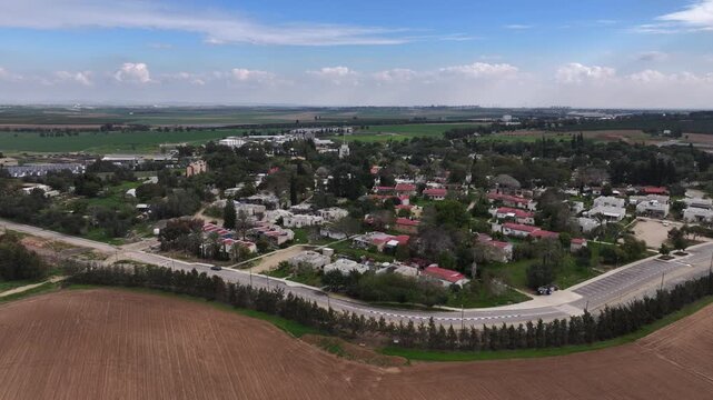 Aerial Kfar Aza kibbutz landscape rural Israel

Drone footage Kfar Aza kibbutz homes and fields Israel October 7 2024
