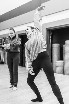 Female dancers rehearsing movement choreography in studio