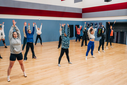 Diverse women taking group fitness class in gym