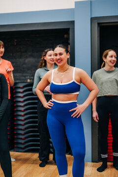Happy woman participating in fitness group class
