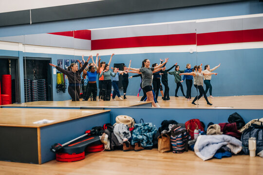 Group of women dancing in a mirror-filled studio