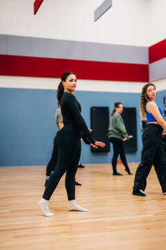 Group of women rehearsing dance movements in a studio