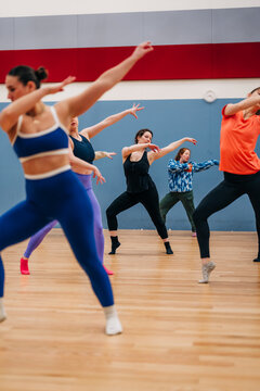 Women performing dynamic dance fitness routine in studio