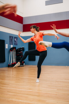 Female dancers rehearsing energetic modern choreography in studio
