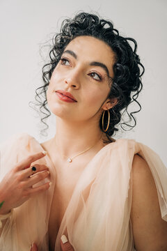 Thoughtful confident woman looking up wearing jewelry
