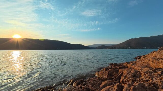 Static Lake Shot with Sunset Sun Peeking Above Hills &ndash; Autumn Evening. Location: Bovan Lake. Balkans, Serbia.