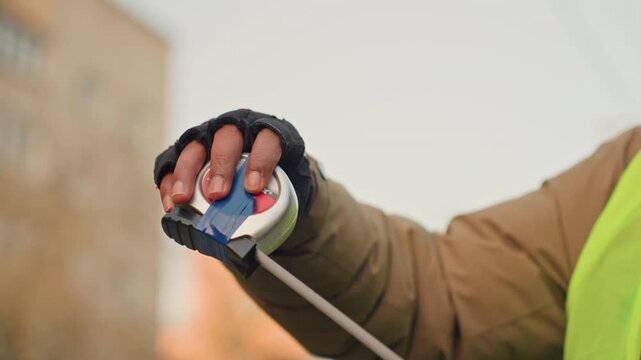 Contractor measuring tape on wood plank, focused expression and gloves while checking alignment for repair, outdoor construction backdrop, final inspection before cut, professional concentration