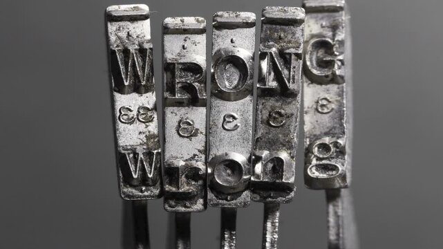The word WRONG with antique typewriter hammers stop motion loop 